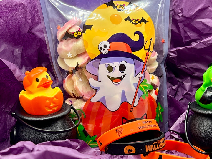 MJ's Halloween-themed bag containing ghost and pumpkin candies and novelties